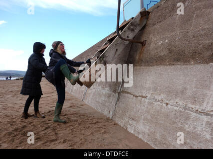 Exmouth beach, post storm damage, trying to use the now higher beach steps, Devon, Britain, UK Stock Photo