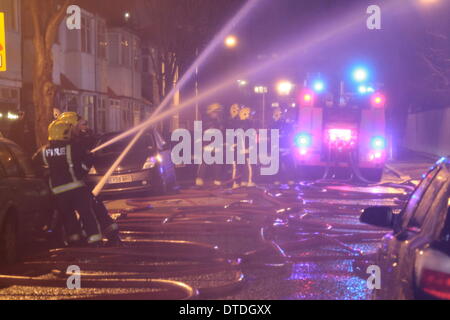 London, UK. 16th February 2014. 100 Firefighters tackle a warehouse fire in Canning Town. One man was rescued and taken to hospital as crews from across London were sent to the scene. The fire is thought to have started at around 11:00pm Saturday and was brought under control by around 2:00m Sunday morning. Credit:  HOT SHOTS/Alamy Live News Stock Photo