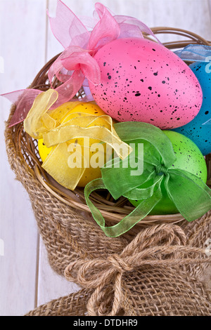 Easter eggs in a basket on a light background Stock Photo