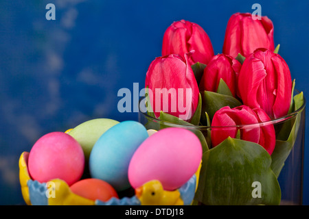 Easter eggs and tulips in a vase Stock Photo