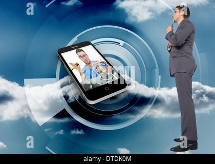 Composite image of thoughtful businessman holding pen to chin Stock Photo