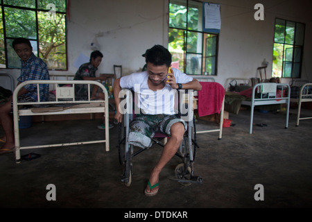 Kachin's militia member Lalaw Ze Dai, from Waimaw village, 25, talk on the phone with his girlfriend Stock Photo