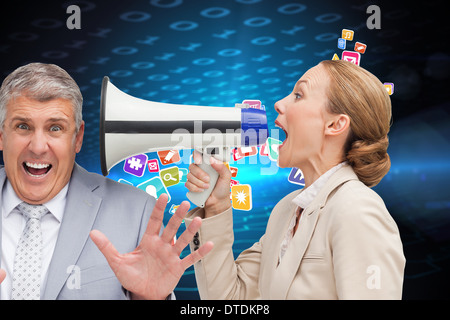 Composite image of businesswoman using a megaphone at her colleague Stock Photo
