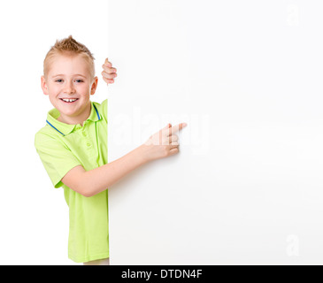 Handsome kid boy pointing to blank advertisement banner Stock Photo