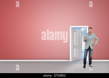 Composite image of stylish man smiling and gesturing Stock Photo