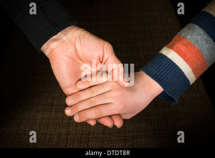 Two hands caught. Adult and child hand Stock Photo
