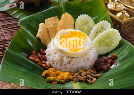 nasi lemak, a traditional malay curry paste rice dish served on a banana leaf Stock Photo