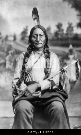 Sitting Bull, three-quarter-length portrait, seated, facing front, holding calumet, circa 1881 Stock Photo