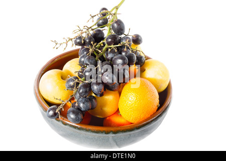 A bowl of fruit to include oranges and grapes Stock Photo