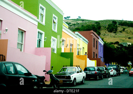 Houses in the formerly Malay Bo-kaap district of Cape Town, Signal Hill beyond, are painted in vivid colours Stock Photo