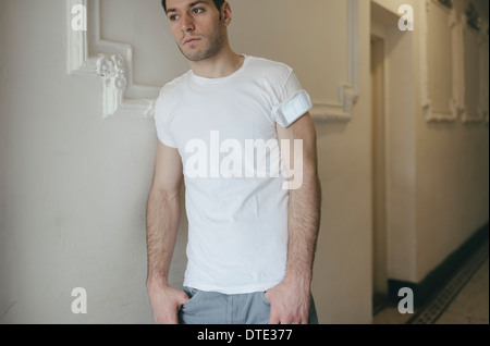 Part of series showing different ways one carries a smartphone, folded in t-shirt sleeve oldschool style. Stock Photo