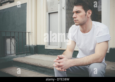 cigarette in shirt sleeve Part of series showing different ways one carries a smartphone, folded in t-shirt  sleeve as older generation carried cigarettes Stock Photo
