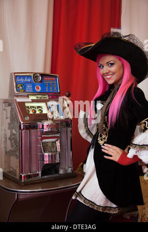 'Sega One-armed Bandit' Vintage slots, three reel fruit slot machines.   Buccaneer playing Coin-Operated Fruit Machine at Blackpool's annual festival. Stock Photo