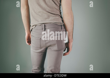 Part of series showing different ways one carries a smartphone, in the back pocket of tight jeans Stock Photo