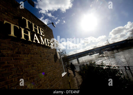 Staines Surrey, UK. 16th February 2014. A pub sign  called The Thames on the banks of the river .Rising water levels continue along parts of the River Thames following unprecedented bad weather  bringing misery to residents despite improving sunny weather over the weekend © amer ghazzal/Alamy Live News Credit:  amer ghazzal/Alamy Live News Stock Photo