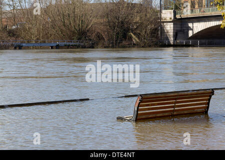 Staines Surrey, UK. 16th February 2014. A public bench partially submerged in water. Rising water levels continue along parts of the River Thames following unprecedented bad weather  bringing misery to residents despite improving sunny weather over the weekend © amer ghazzal/Alamy Live News Credit:  amer ghazzal/Alamy Live News Stock Photo