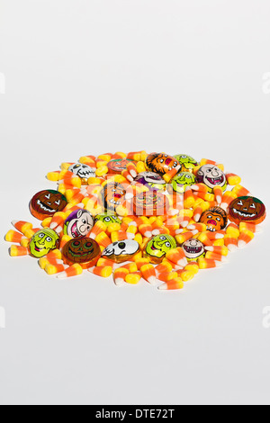 Halloween candy corn sweets colorful trick or treat nobody from above overhead isolated cutout cut out white backgroud table nobody vertical hi-res Stock Photo