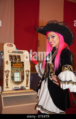 'Sega One-armed Bandit' Vintage slots, three reel fruit slot machines.   Buccaneer playing Coin-Operated Fruit Machine at Blackpool's annual festival. Stock Photo