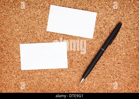 Two business cards and pen on cork wood notice board Stock Photo