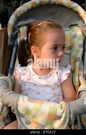 One and half year old girl sitting in the stroller Stock Photo