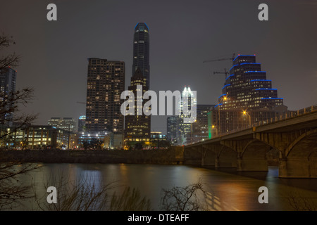 HDR image of a partial skyline of Austin, Texas over the water of Lady Bird Lake at night Stock Photo