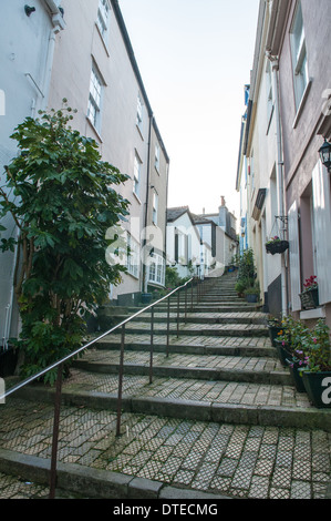 Pretty colourful houses along narrow steps in a cobbled lane in the quaint old town area of historic Dartmouth in Devon Stock Photo