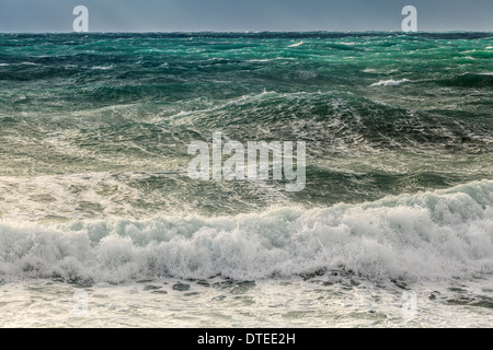 Waves of light from the rising sun, on a background of blue sky Stock Photo