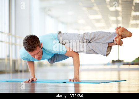Man practicing difficult asana Stock Photo