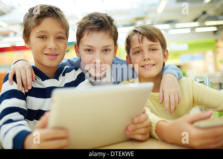 Portrait of three boys sitting in cafe Stock Photo