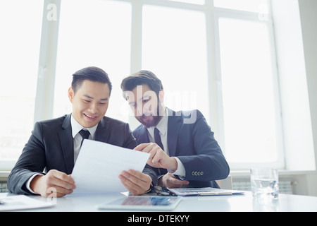 Two managers discussing contract in meeting room Stock Photo