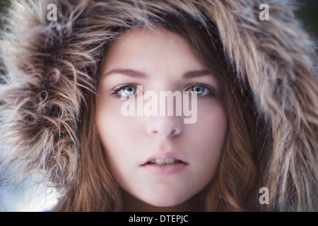 Portrait of young woman wearing fur hat Stock Photo