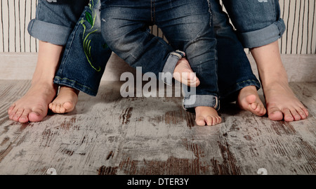 mom and daughters barefoot in jeans Stock Photo