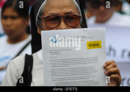 Manila, Philippines. 17th Feb, 2014. MANILA, Philippines - A representative of the group displays their letter of demands, that according to them was rejected by the office of the President.100 days after the super-typhoon Haiyan (locally known as Yolanda) hit Central Visayas, an alliance of survivors of the typhoon called ''People Surge'' and other groups stormed the Malacanang Presidential Palace in Manila on 17 February 2014. The protesters said that the Aquino government is facing the mounting anger of the people of Eastern Visayas over its failure to lift them from their misery. (Credit Stock Photo