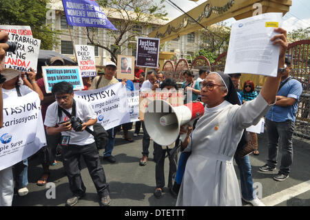 Manila, Philippines. 17th Feb, 2014. MANILA, Philippines - A representative of the group displays their letter of demands, that according to them was rejected by the office of the President.100 days after the super-typhoon Haiyan (locally known as Yolanda) hit Central Visayas, an alliance of survivors of the typhoon called ''People Surge'' and other groups stormed the Malacanang Presidential Palace in Manila on 17 February 2014. The protesters said that the Aquino government is facing the mounting anger of the people of Eastern Visayas over its failure to lift them from their misery. (Credit Stock Photo