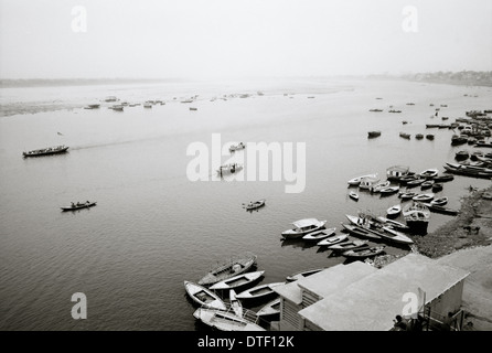 River Ganges in Varanasi Benares in Uttar Pradesh in India in South Asia. Sail Sailing Boat Boating Landscape View Serenity Travel Wanderlust Stock Photo