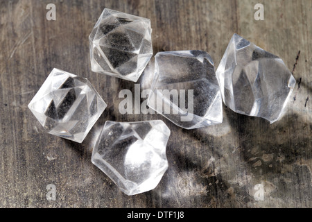 Imitation crystals made from molded plastic shot on an old wooden table Stock Photo