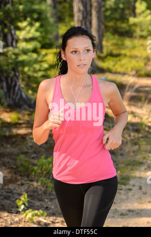 Woman running in the countryside training with headphones Stock Photo