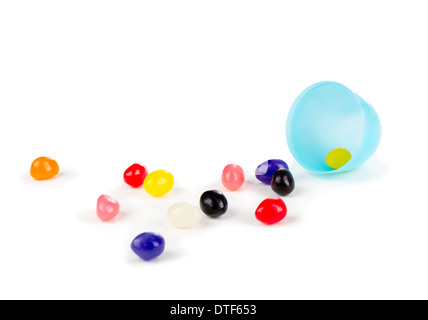 Colorful jelly beans spilled out of a plastic Easter egg. Stock Photo