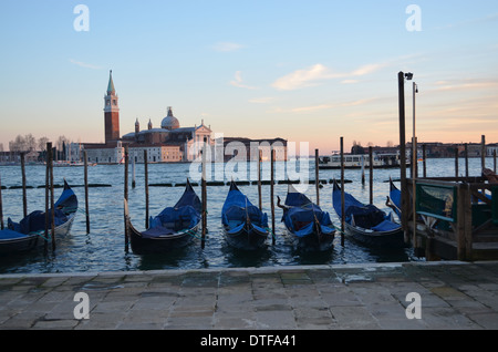 Venice, Italy, Against a background of St Giorgios, Gondolas lie still at the end of the day. It is a scene that typifies Venice