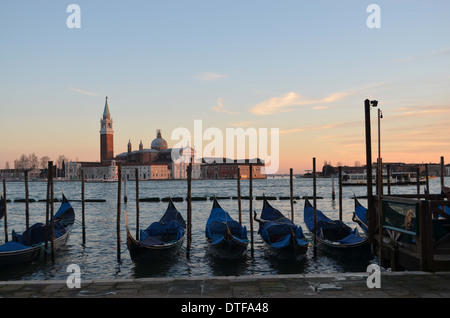 Venice, Italy, Against a background of St Giorgios, Gondolas lie still at the end of the day. It is a scene that typifies Venice