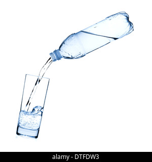 Water is poured into a glass from a bottle. Isolated on white background Stock Photo