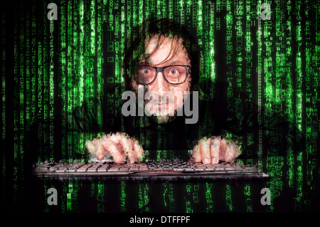 Hacker in Action on the keyboard with matrix background Stock Photo
