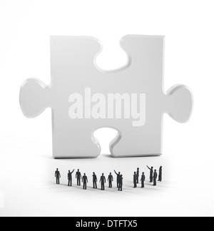 Tiny people looking and a jigsaw puzzle piece Stock Photo