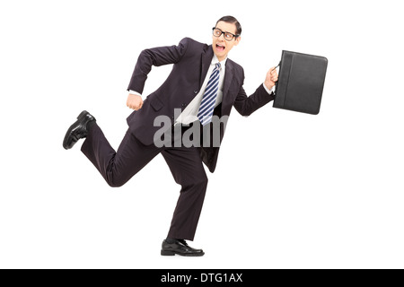 Scared male businessman running away from something Stock Photo