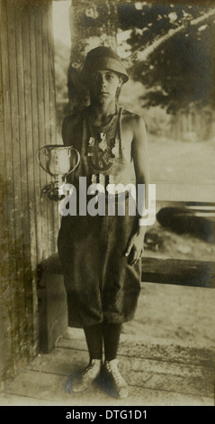 1910 photograph of a Camp Kineo camper showing off his trophy and medals. Stock Photo