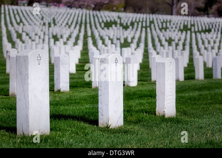 Symmetrical rows of tombs from our brave men and woman of the United States Military, resting at Arlington National Cemetery,in Virginia. Stock Photo