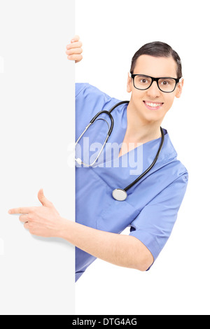 Male doctor pointing on a blank panel Stock Photo