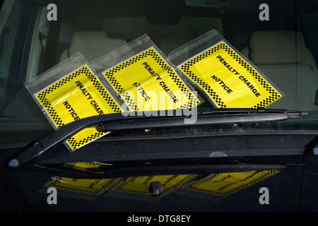 Three parking tickets on car window. Stock Photo