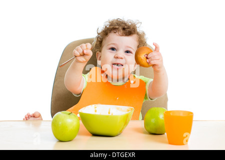 baby eating by himself Stock Photo