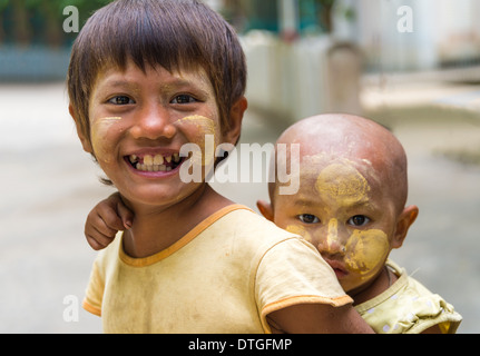 MANDALAY, MYANMAR - CIRCA DECEMBER 2013: Happy Burmese children playing in the streets of Amarpura in Myanmar Stock Photo